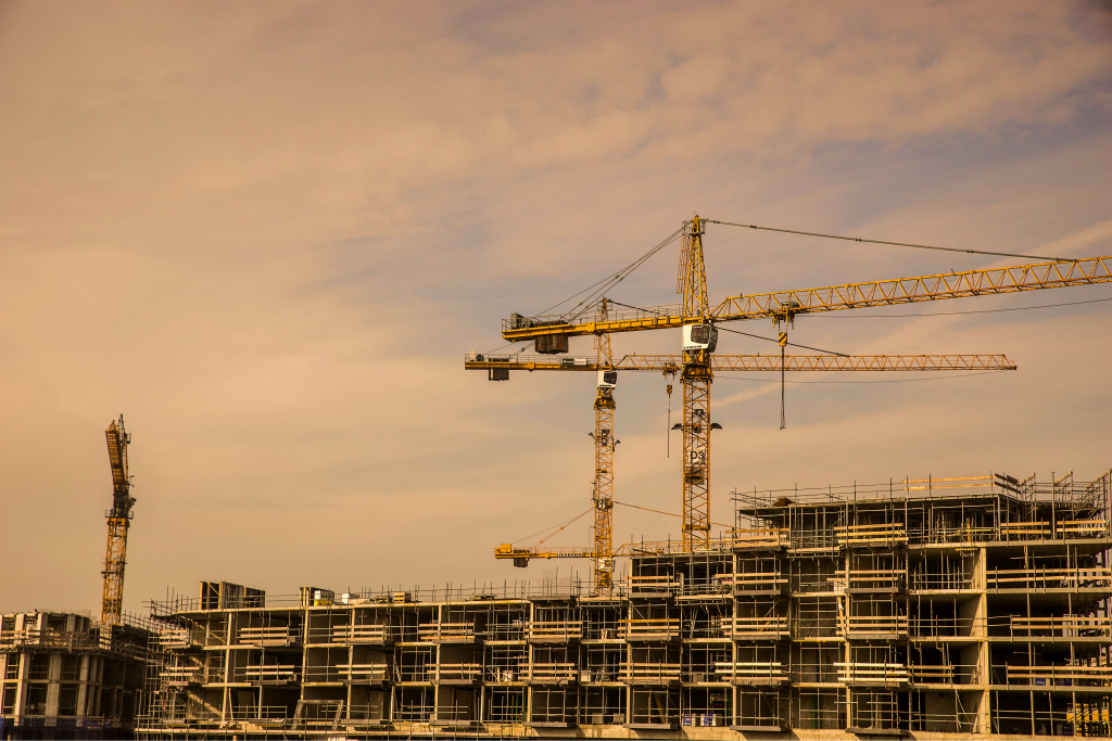 Tower cranes over a concrete building frame