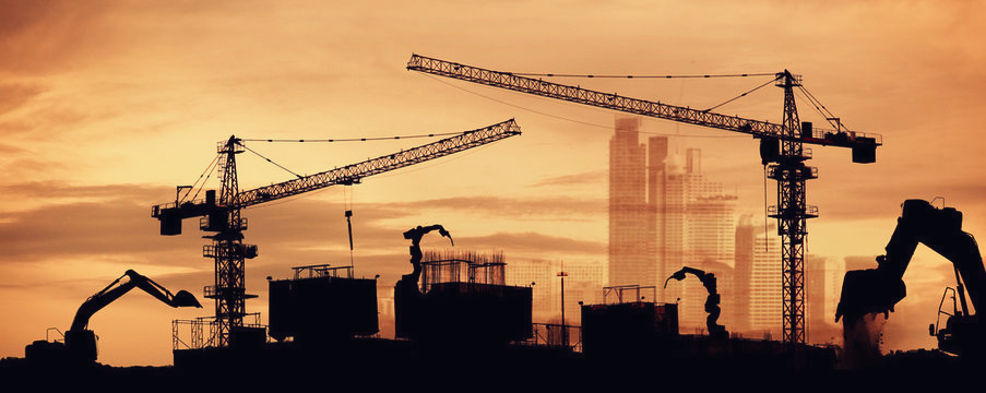 Construction site at sunset with a tower crane